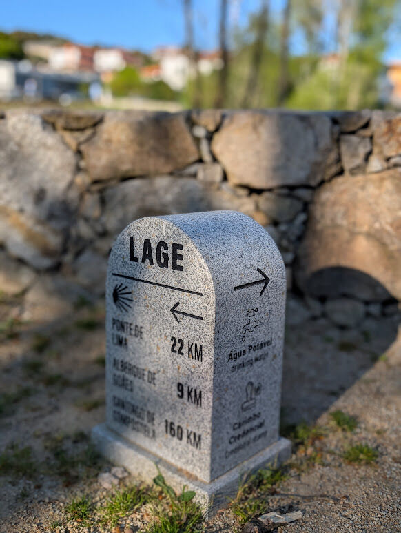 Granite Camino milestone in Lage showing 160 km to Santiago de Compostela